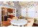 Inviting breakfast nook featuring a round table, cozy seating, brick accent wall, and hardwood flooring at 7594 W Williamswood Dr, New Palestine, IN 46163