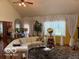 Inviting living room with vaulted ceilings, hardwood floors, and neutral décor, creating a comfortable and stylish space at 7594 W Williamswood Dr, New Palestine, IN 46163