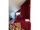 Cozy bedroom with red wallpaper and comfortable bedding, creating a warm and inviting space at 7594 W Williamswood Dr, New Palestine, IN 46163