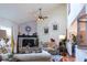 Stylish living room with a brick fireplace, vaulted ceilings, and plenty of natural light, perfect for relaxing or entertaining at 7594 W Williamswood Dr, New Palestine, IN 46163