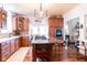 Spacious kitchen with wood cabinets, granite countertops, stainless steel appliances, and modern light fixture at 7594 W Williamswood Dr, New Palestine, IN 46163