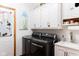 Laundry room with white cabinets and modern washer and dryer at 7594 W Williamswood Dr, New Palestine, IN 46163