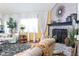 Elegant living room featuring brick fireplace, hardwood floors, and bright windows at 7594 W Williamswood Dr, New Palestine, IN 46163