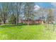Spacious backyard with grass, mature trees, and a chain link fence at 7825 N County Road 650 E, Brownsburg, IN 46112