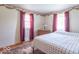Bright bedroom with a large bed, classic decor, and carpet flooring at 7825 N County Road 650 E, Brownsburg, IN 46112