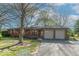 Charming brick ranch-style home featuring an attached two-car garage, well-maintained landscaping, and a welcoming front entrance at 7825 N County Road 650 E, Brownsburg, IN 46112