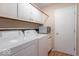 Well-organized laundry room features cabinets, shelving, and a washer and dryer at 7825 N County Road 650 E, Brownsburg, IN 46112