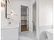 Bright bathroom features a modern vanity, updated lighting, and an en suite bathroom at 8083 Easton Ln, Zionsville, IN 46077
