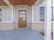 Elegant front door with a glass panel, complemented by stylish brick accents at 8083 Easton Ln, Zionsville, IN 46077