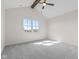 Spacious empty bedroom with neutral walls, vaulted ceilings with a ceiling fan, and a large window at 8083 Easton Ln, Zionsville, IN 46077