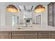 Kitchen featuring marble countertops, pendant lighting, island sink and open-concept to living room at 8083 Easton Ln, Zionsville, IN 46077
