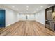 Spacious finished basement with hardwood flooring, recessed lighting, and a modern wet bar at 8083 Easton Ln, Zionsville, IN 46077