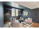 Finished basement sitting area features modern lighting, dark gray walls, and elegant decor at 8083 Easton Ln, Zionsville, IN 46077