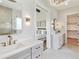 Elegant bathroom featuring double vanity sinks and a view into the main bedroom at 8083 Easton Ln, Zionsville, IN 46077