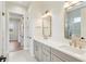 Bathroom featuring double vanity, large mirrors and tiled floors at 8083 Easton Ln, Zionsville, IN 46077