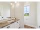 Powder room featuring stone countertop and wood floor at 8083 Easton Ln, Zionsville, IN 46077
