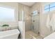 Bright bathroom with a glass-enclosed shower next to a soaking tub beneath a frosted window at 8083 Easton Ln, Zionsville, IN 46077