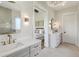 Elegant bathroom featuring double vanity sinks and a view into the main bedroom at 8083 Easton Ln, Zionsville, IN 46077