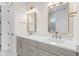 Bathroom with double vanity, modern lighting fixtures, and large mirrors over each sink at 8083 Easton Ln, Zionsville, IN 46077