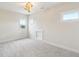 Bright, carpeted bedroom featuring a modern light fixture and multiple windows at 8083 Easton Ln, Zionsville, IN 46077