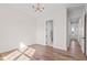Bedroom with hardwood floors, contemporary light fixture, and access to a hallway and en-suite bathroom at 8083 Easton Ln, Zionsville, IN 46077