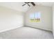 Bedroom with vaulted ceiling, ceiling fan, and a large window at 8083 Easton Ln, Zionsville, IN 46077