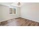 Well-lit bedroom with hardwood floors and a bright window offering ample natural light at 8083 Easton Ln, Zionsville, IN 46077