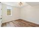 Bedroom features hardwood floors, a window, and a ceiling fan for comfort at 8083 Easton Ln, Zionsville, IN 46077