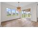 Bright dining area with large windows, sliding glass doors to patio, and a stylish light fixture at 8083 Easton Ln, Zionsville, IN 46077