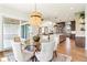 Open dining area with modern lighting, access to outdoor space, and view of open kitchen at 8083 Easton Ln, Zionsville, IN 46077