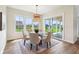 Bright dining area features modern lighting, large windows with backyard views, and access to an outdoor space at 8083 Easton Ln, Zionsville, IN 46077