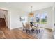 Bright dining area features modern lighting, large windows, and classic rug at 8083 Easton Ln, Zionsville, IN 46077