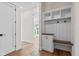 Welcoming mudroom area with a built-in bench, storage cabinets, and coat hooks at 8083 Easton Ln, Zionsville, IN 46077