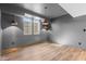 Finished basement featuring wood grain flooring, modern pendant lighting, and bright windows at 8083 Easton Ln, Zionsville, IN 46077