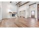 Open living room featuring a stone fireplace, hardwood floors, and a soaring ceiling at 8083 Easton Ln, Zionsville, IN 46077