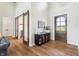 Bright foyer with wood floors, sliding barn doors, and sophisticated furnishings at 8083 Easton Ln, Zionsville, IN 46077
