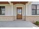 Beautifully crafted wood front door with glass inset for welcoming natural light at 8083 Easton Ln, Zionsville, IN 46077