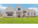 Beautiful new construction home with stone accents, covered porch and manicured lawn at 8083 Easton Ln, Zionsville, IN 46077