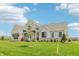 Lovely new construction home with covered front porch and lush green lawn at 8083 Easton Ln, Zionsville, IN 46077