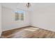 Bright bedroom with wood-look floors and large windows at 8083 Easton Ln, Zionsville, IN 46077