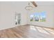 Bright living room featuring hardwood floors, ample natural light, and a view to an en suite bathroom at 8083 Easton Ln, Zionsville, IN 46077