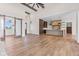Open-concept living space with wood floors, island kitchen, beamed ceilings, and barn door at 8083 Easton Ln, Zionsville, IN 46077