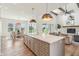 Open kitchen with island, stainless appliances, and view to dining and living areas at 8083 Easton Ln, Zionsville, IN 46077