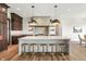 Modern kitchen with a large island, marble countertops, and stainless steel appliances at 8083 Easton Ln, Zionsville, IN 46077