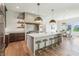 Modern kitchen with a large island, marble countertops, and stainless steel appliances at 8083 Easton Ln, Zionsville, IN 46077