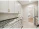 Laundry room featuring granite countertops and a view into the walk-in closet at 8083 Easton Ln, Zionsville, IN 46077