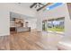 Open concept living room featuring hardwood floors, large windows, and seamlessly connecting to the kitchen at 8083 Easton Ln, Zionsville, IN 46077
