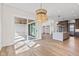 Bright open-concept living area with hardwood floors, modern lighting, and a view to the outdoor patio at 8083 Easton Ln, Zionsville, IN 46077