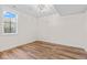Bright bedroom with wood-look floors and a modern ceiling light fixture at 8083 Easton Ln, Zionsville, IN 46077