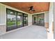 Covered patio boasts brick accents, a wood ceiling, fan, and sliding glass doors to interior at 8083 Easton Ln, Zionsville, IN 46077